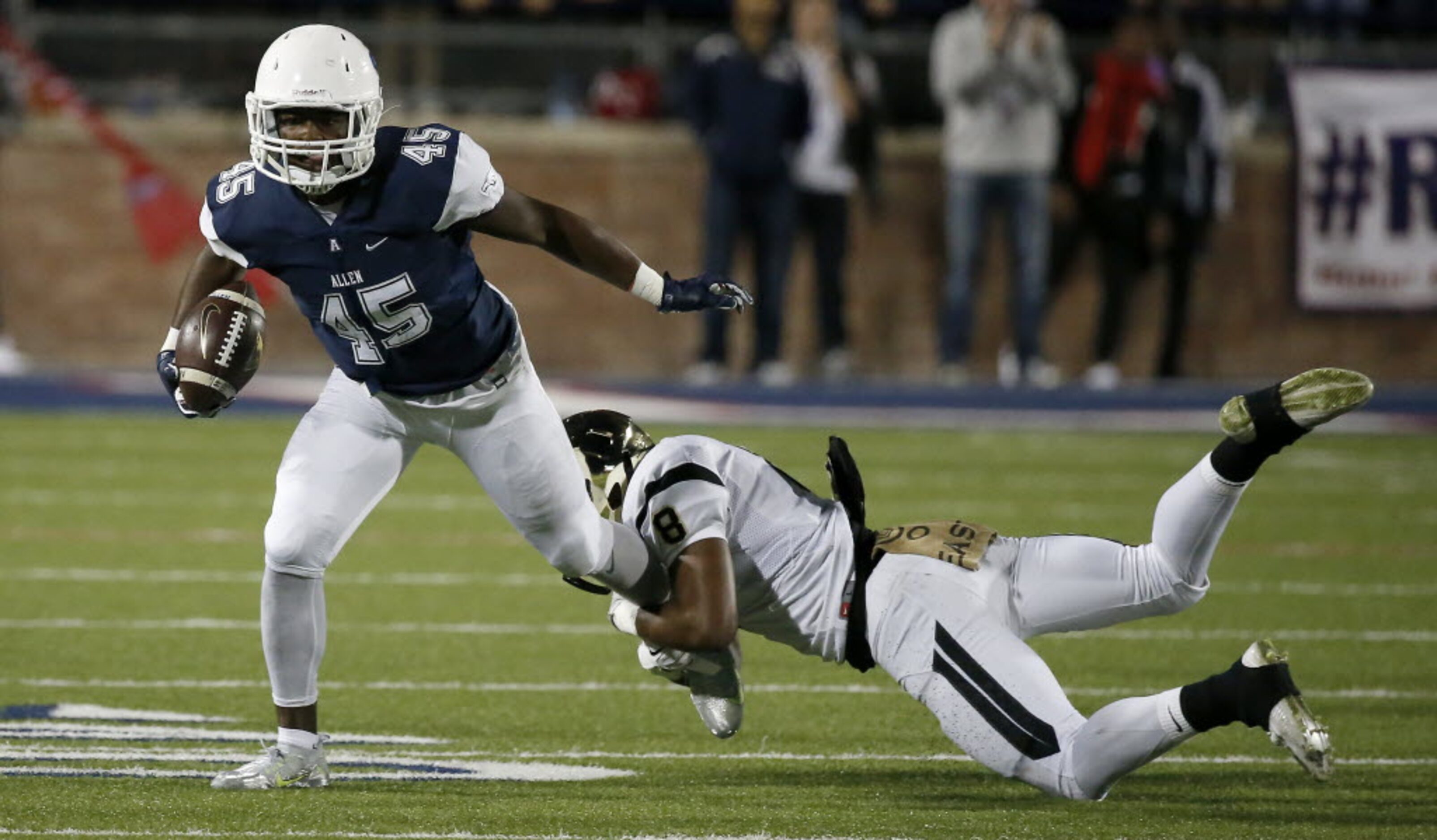 Allen's Kirby Bennett (45) gets tackled by Plano East's Reuben Donald (8) during the first...