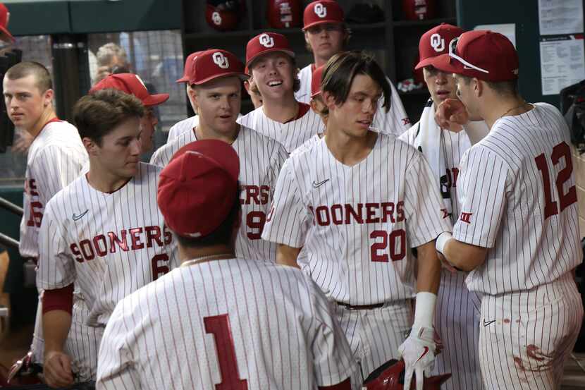 Oklahoma Sooners shortstop Peyton Graham (20), center right, is congratulated in the team...