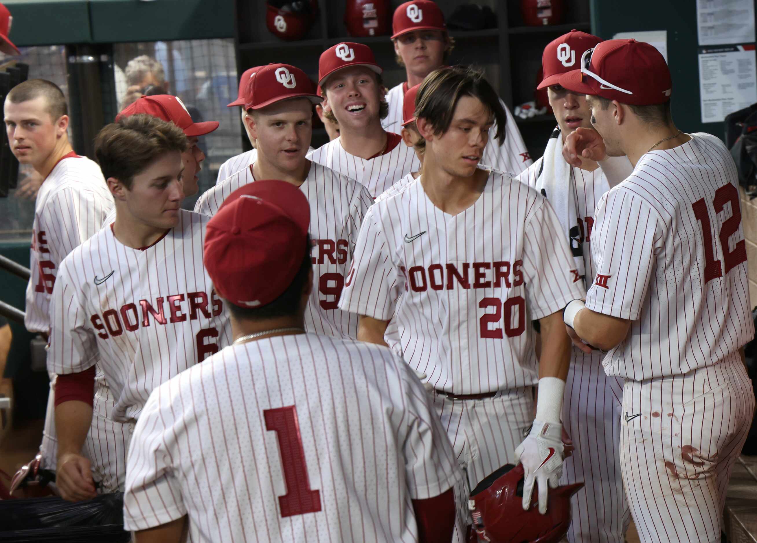 Oklahoma Sooners shortstop Peyton Graham (20), center right, is congratulated in the team...