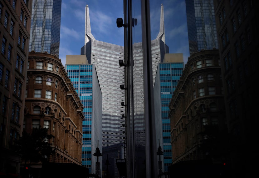 The Republic Bank Center’s 36-story Tower I complete with spire is reflected in the store...