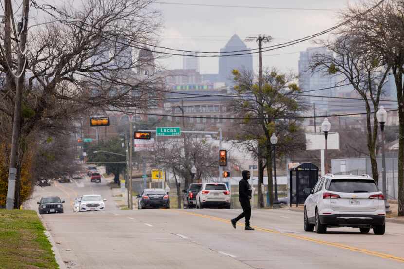 A pedestrian crosses the street close to the intersection of Lucas Drive and Maple Avenue in...