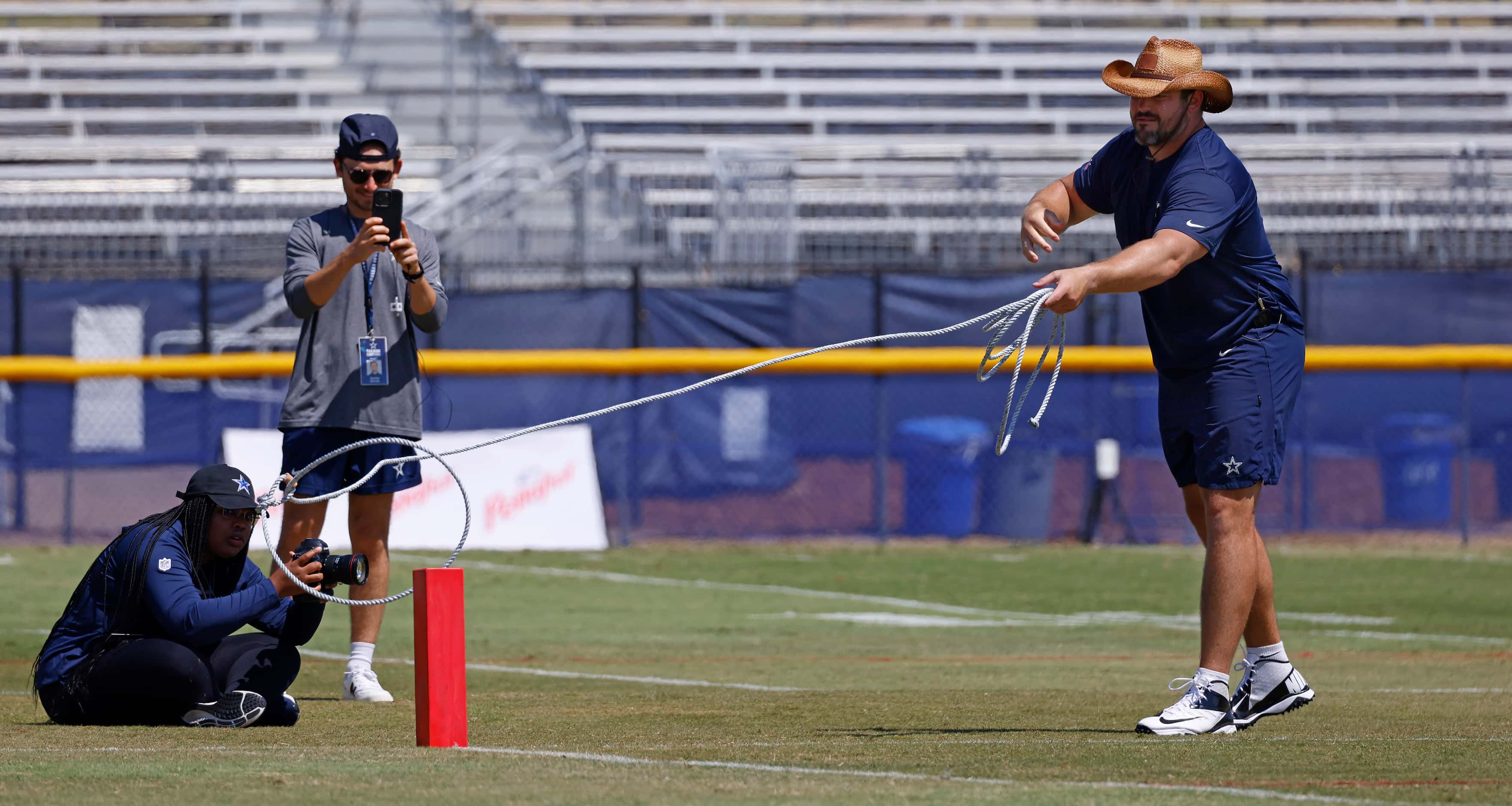 Donning a cowboy hat, Dallas Cowboys guard Zack Martin attempts to lasso a touchdown pylon...
