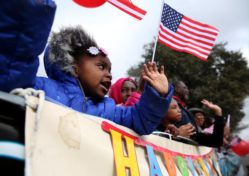 Eternity Wright waves during the Martin Luther King Jr. parade on Martin Luther King, Jr....