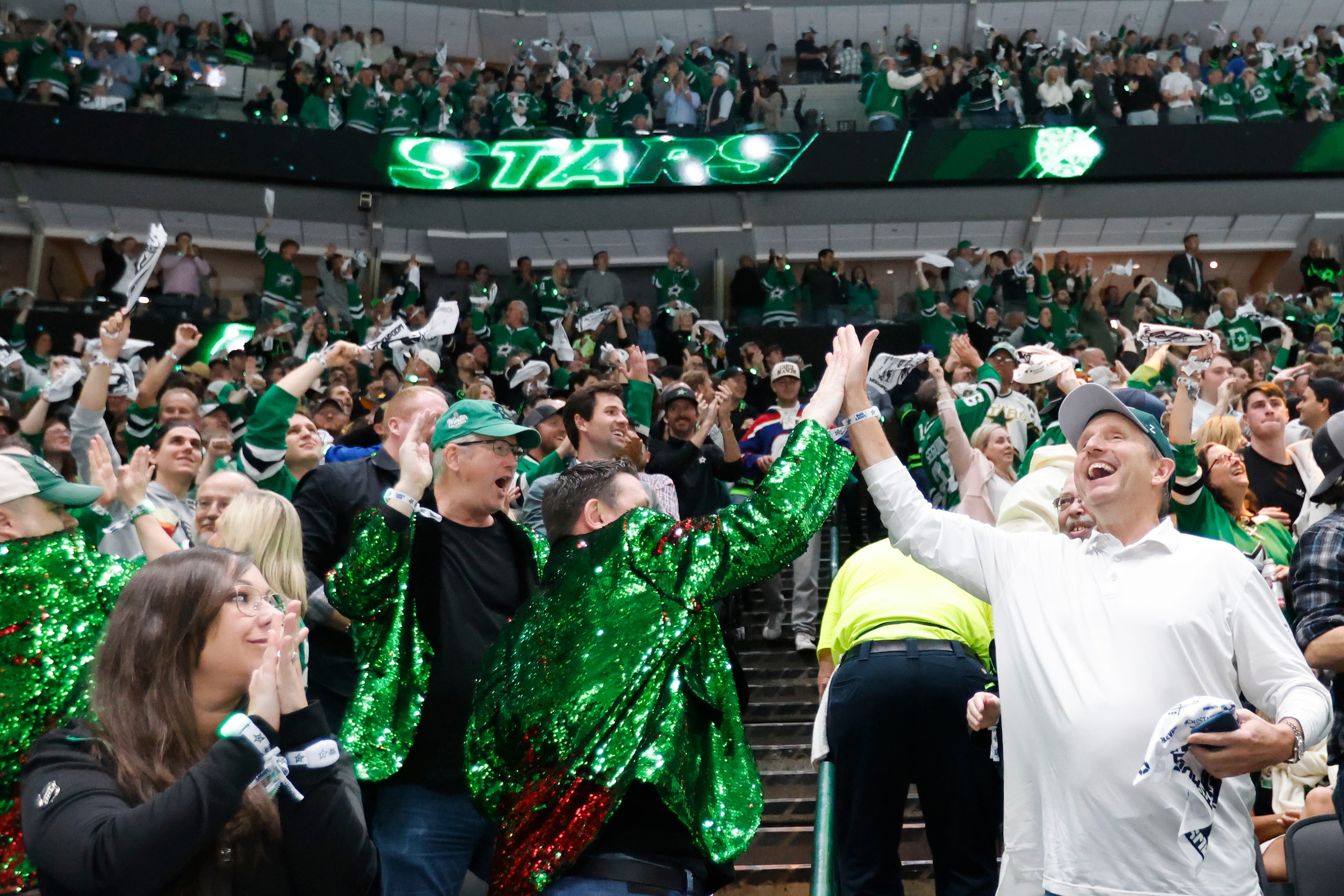 Dallas fans cheer after the team’s third goal during the second period in Game 2 of an NHL...