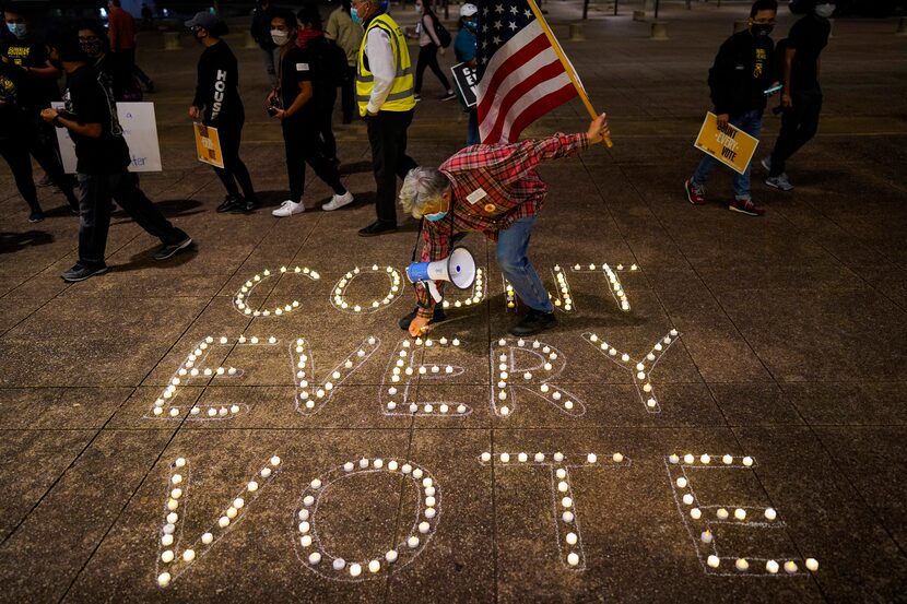 Benny De La Vega lighted candles to highlight the prevailing sentiment during a rally at...