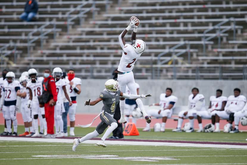 Kimball wide receiver Kyron Henderson catches a pass as South Oak Cliff defensive back Malik...
