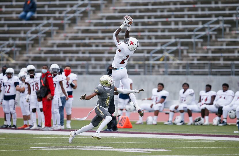 Kimball junior wide receiver Kyron Henderson (2) catches a pass as South Oak Cliff sophomore...