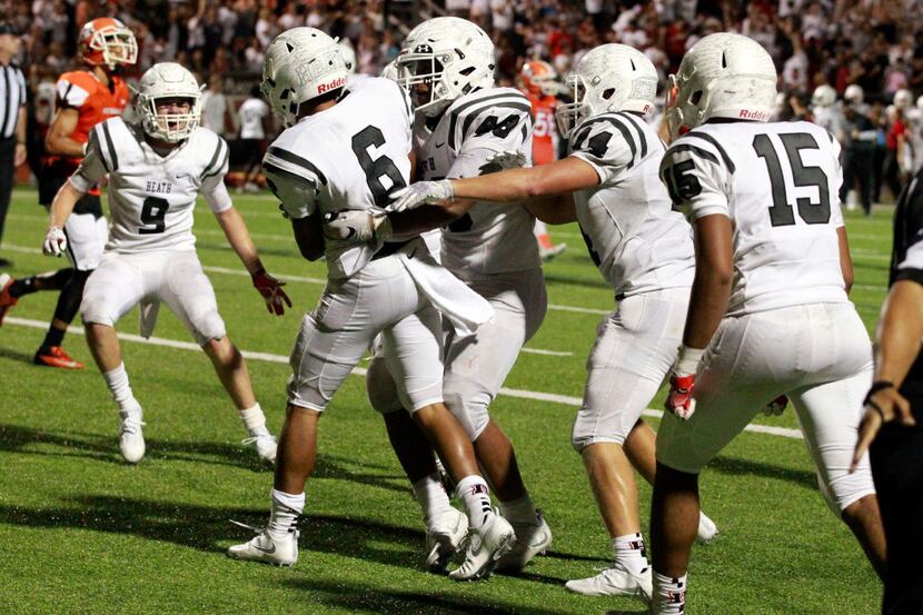 Heath High teammates, including Jackson Salley (9) swarm Kendell Jimerson (6), after he made...
