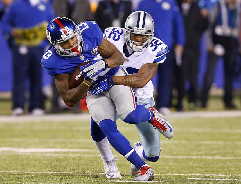 Dallas Cowboys cornerback Orlando Scandrick (32) makes a open field tackle of New York...