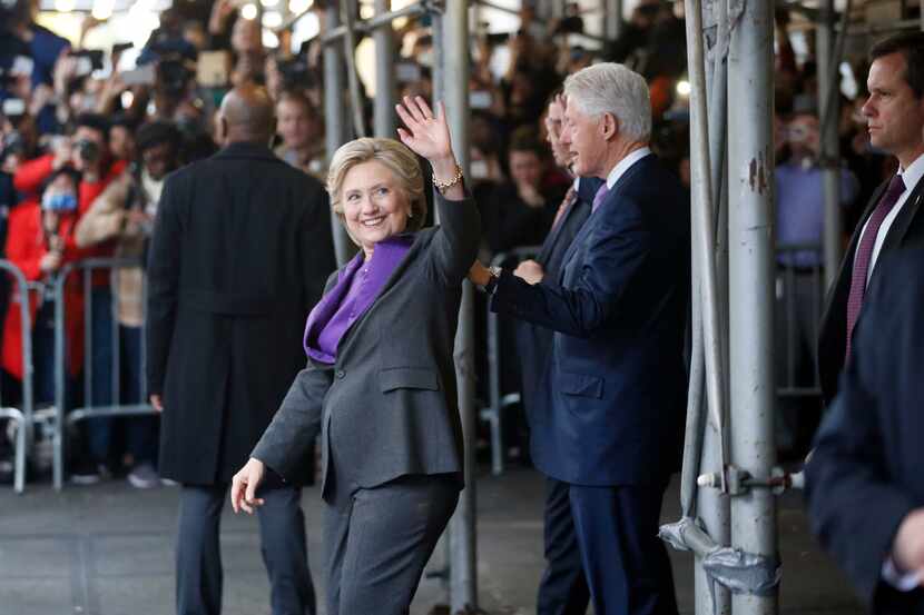 Hillary Clinton and former President Bill Clinton exit the New Yorker Hotel after addressing...