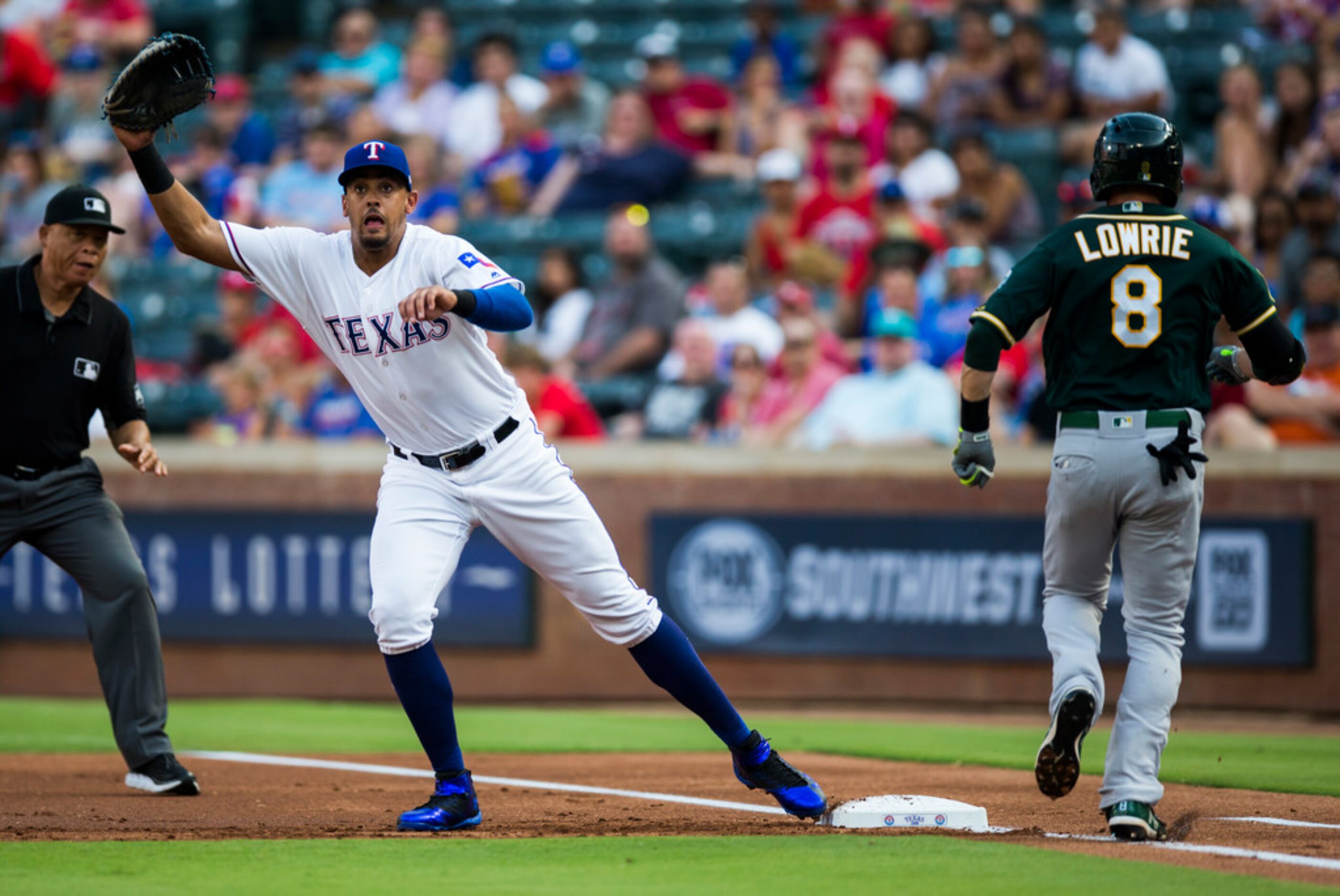 Texas Rangers first baseman Ronald Guzman (67) looks for a throw to first as Oakland...