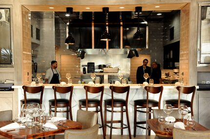 The chef's table, which looks into the kitchen, seats six.