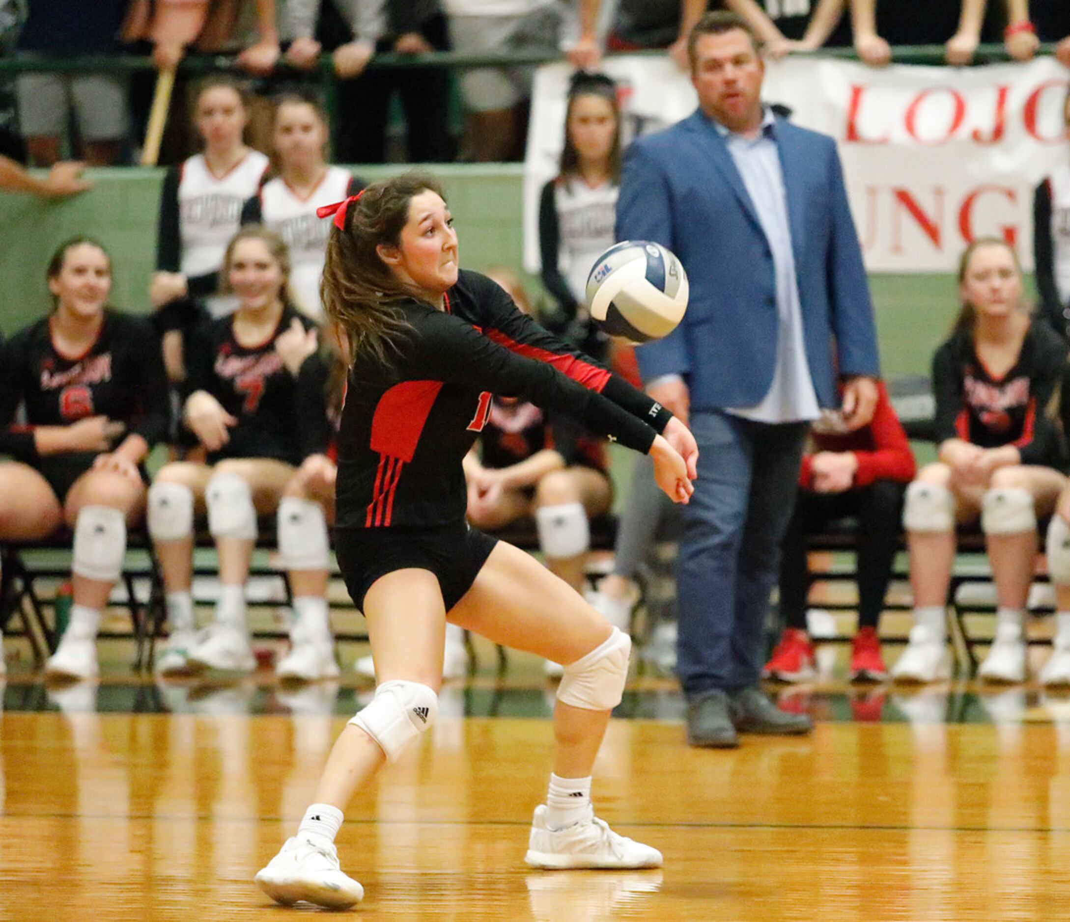 Lovejoy High School defensive specialist Emma Johnson (16) takes a serve in game three as...