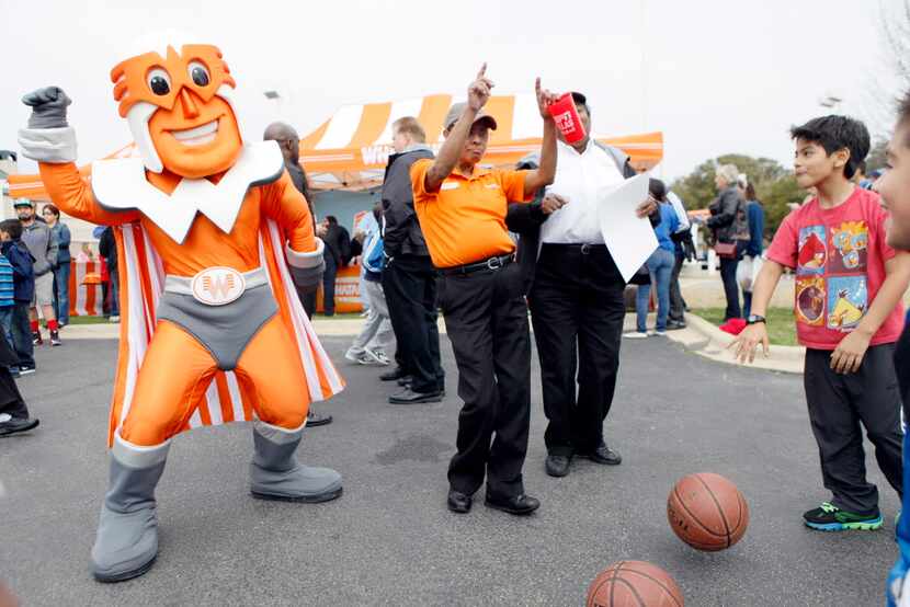 Whataburger employees Sheree Tanner, left, and Melinda Patterson, dance with Whataburger...