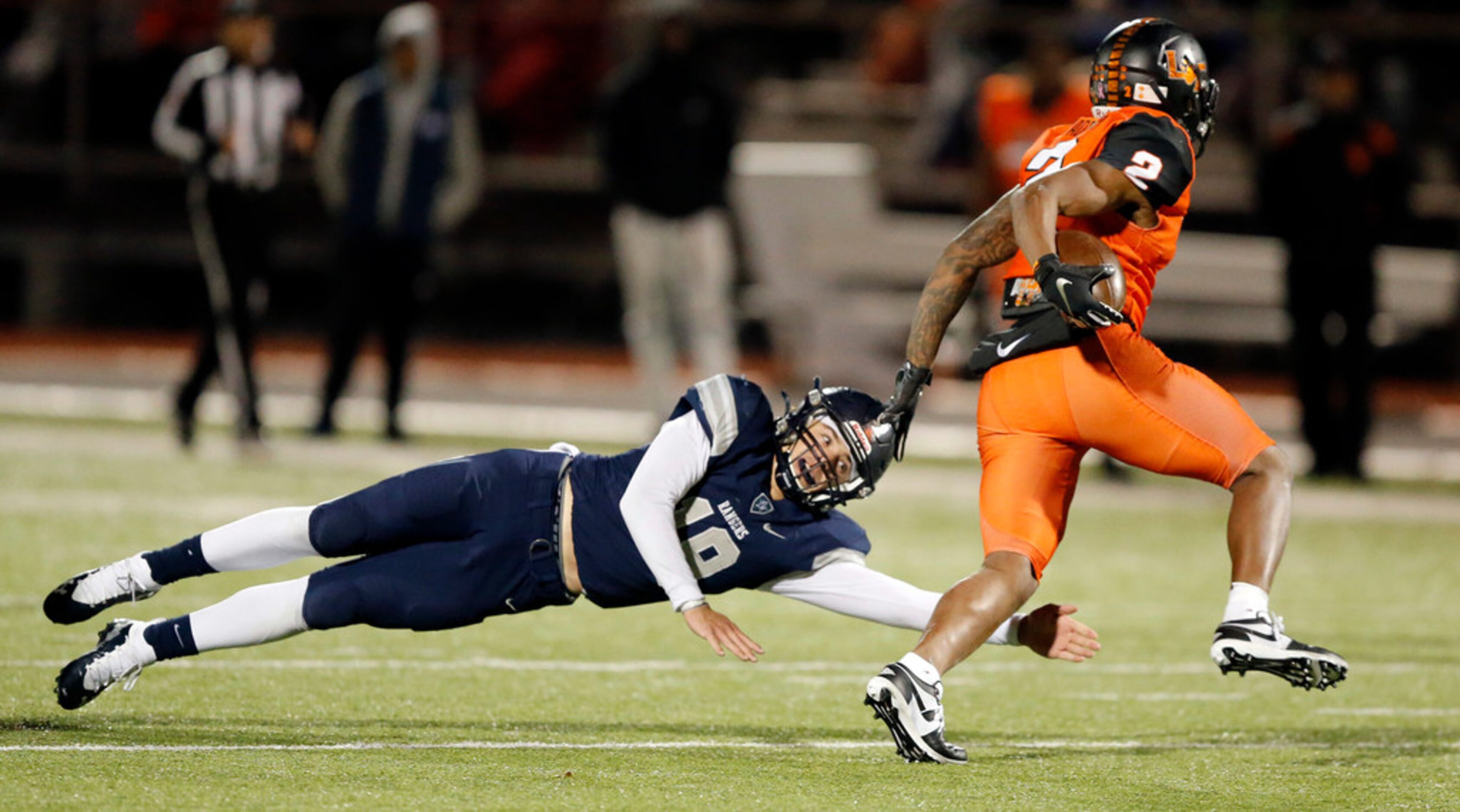 Frisco Lone Star linebacker Landon Whitley (19) reaches for Lancaster running back Tre...