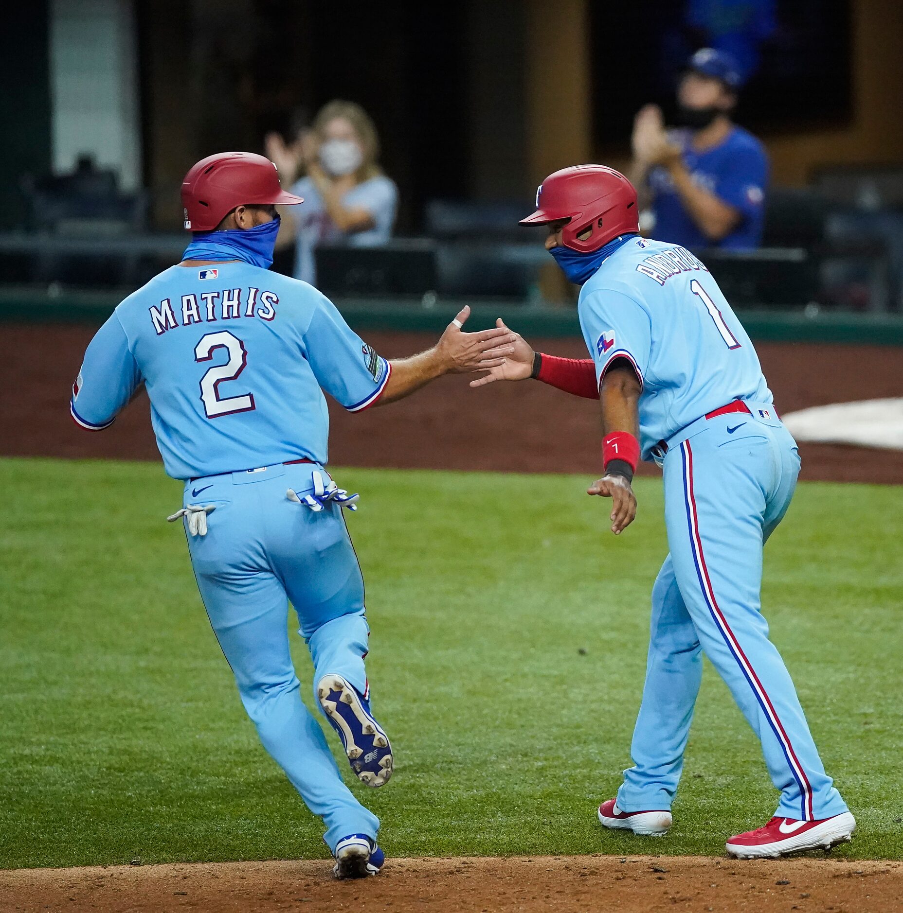 Texas Rangers catcher Jeff Mathis celebrates with shortstop Elvis Andrus after both scored...