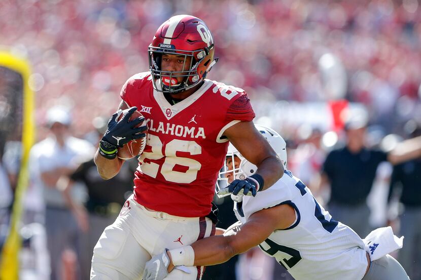 Oklahoma running back Kennedy Brooks (26) runs for a first down against West Virginia during...