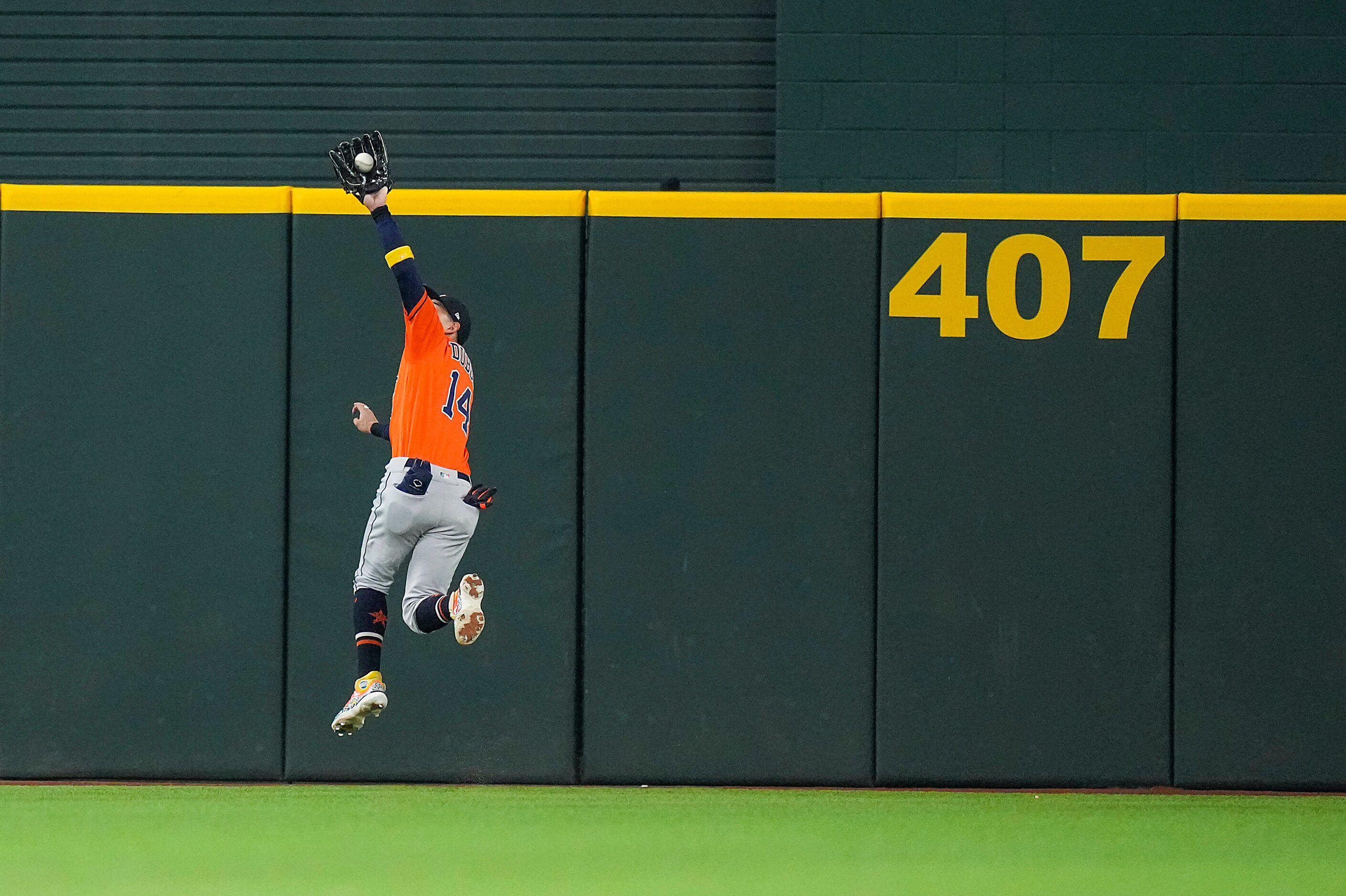 Houston Astros center fielder Mauricio Dubon catches a line drive by Texas Rangers left...