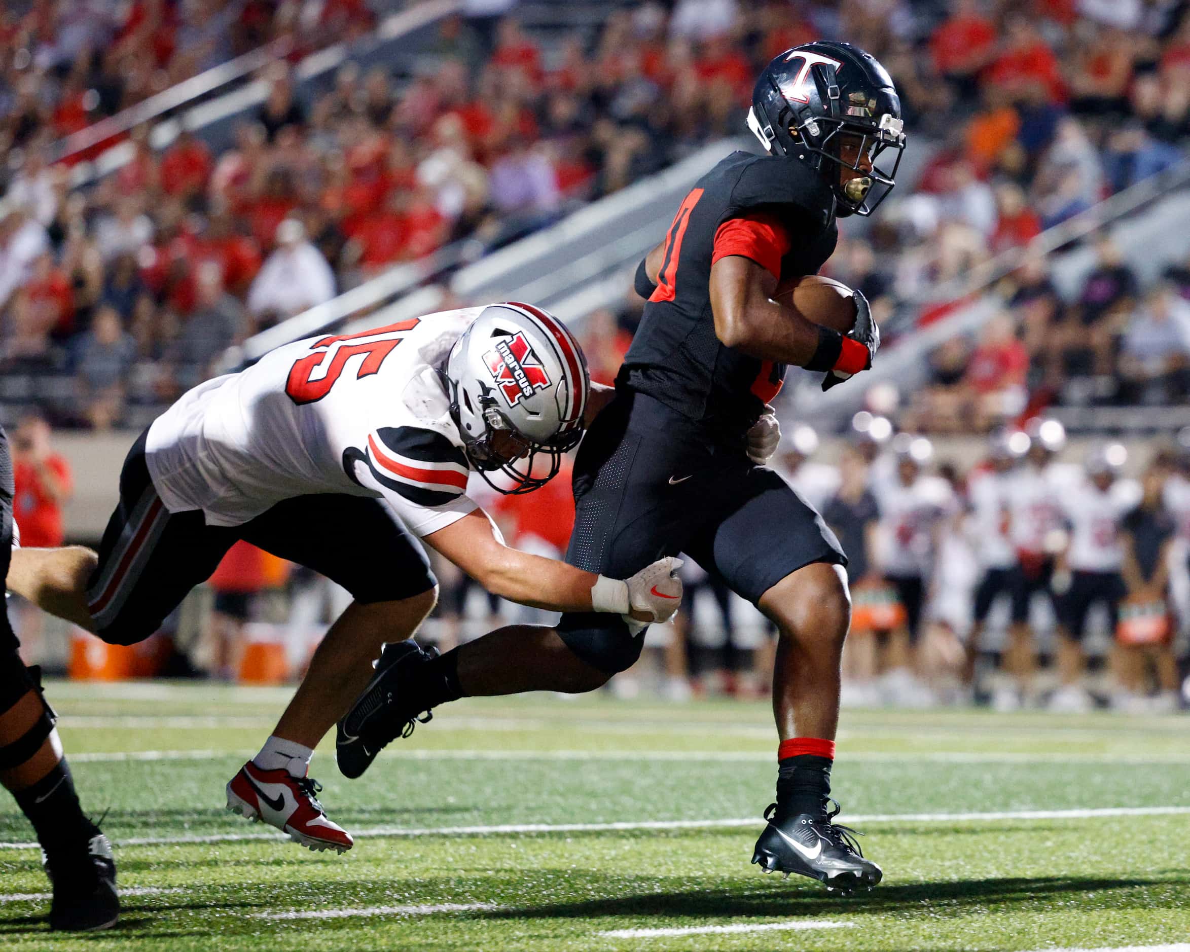 Euless Trinity running back Josh Bell (20) runs for a touchdown ahead of Flower Mound...