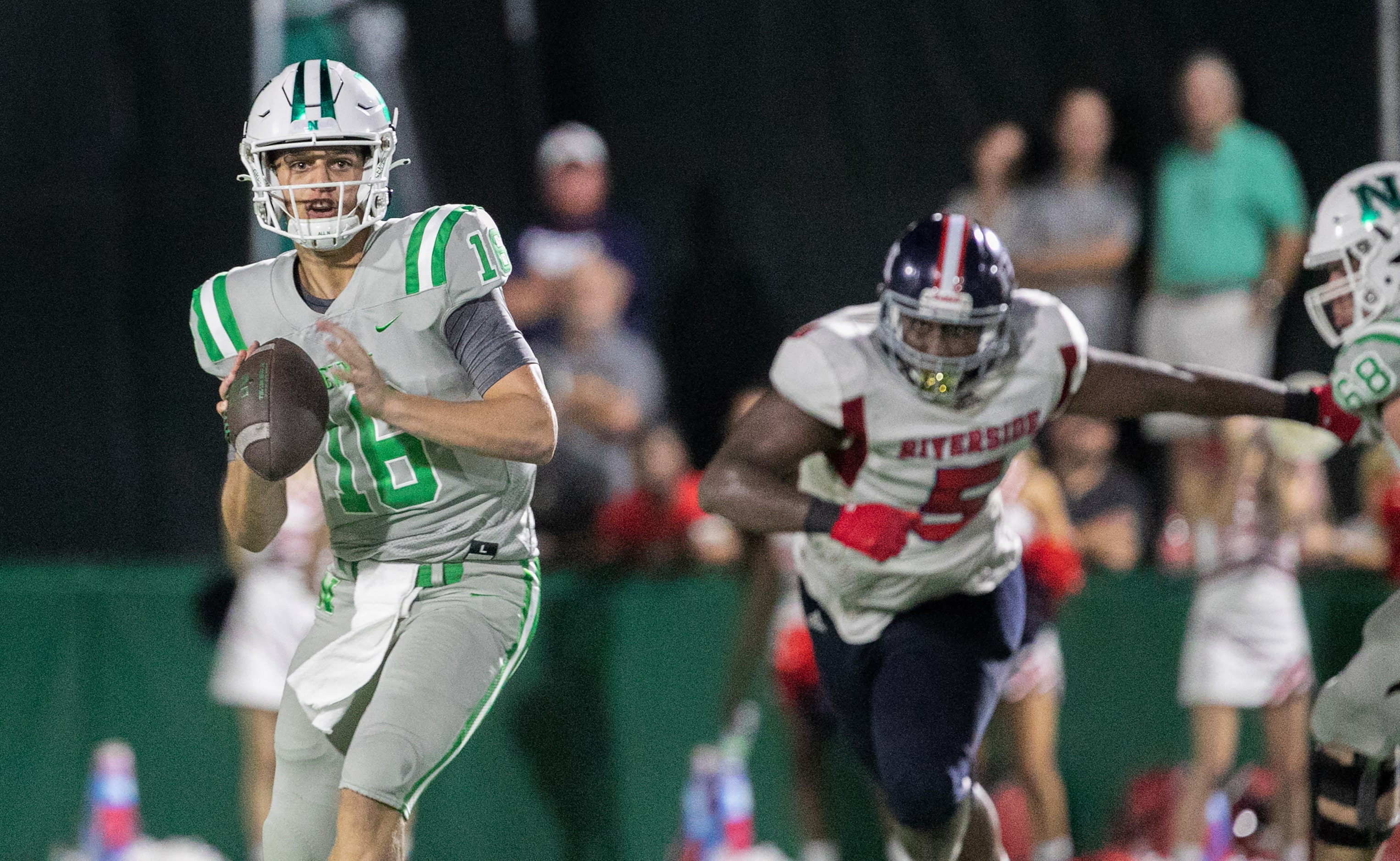 Arch Manning looks for a receiver as Newman High School takes on Riverside Academy Friday,...