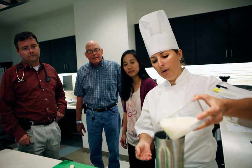 Chef Zoe Muller (right) prepares a strawberry and banana smoothie for cancer patient Kevin...