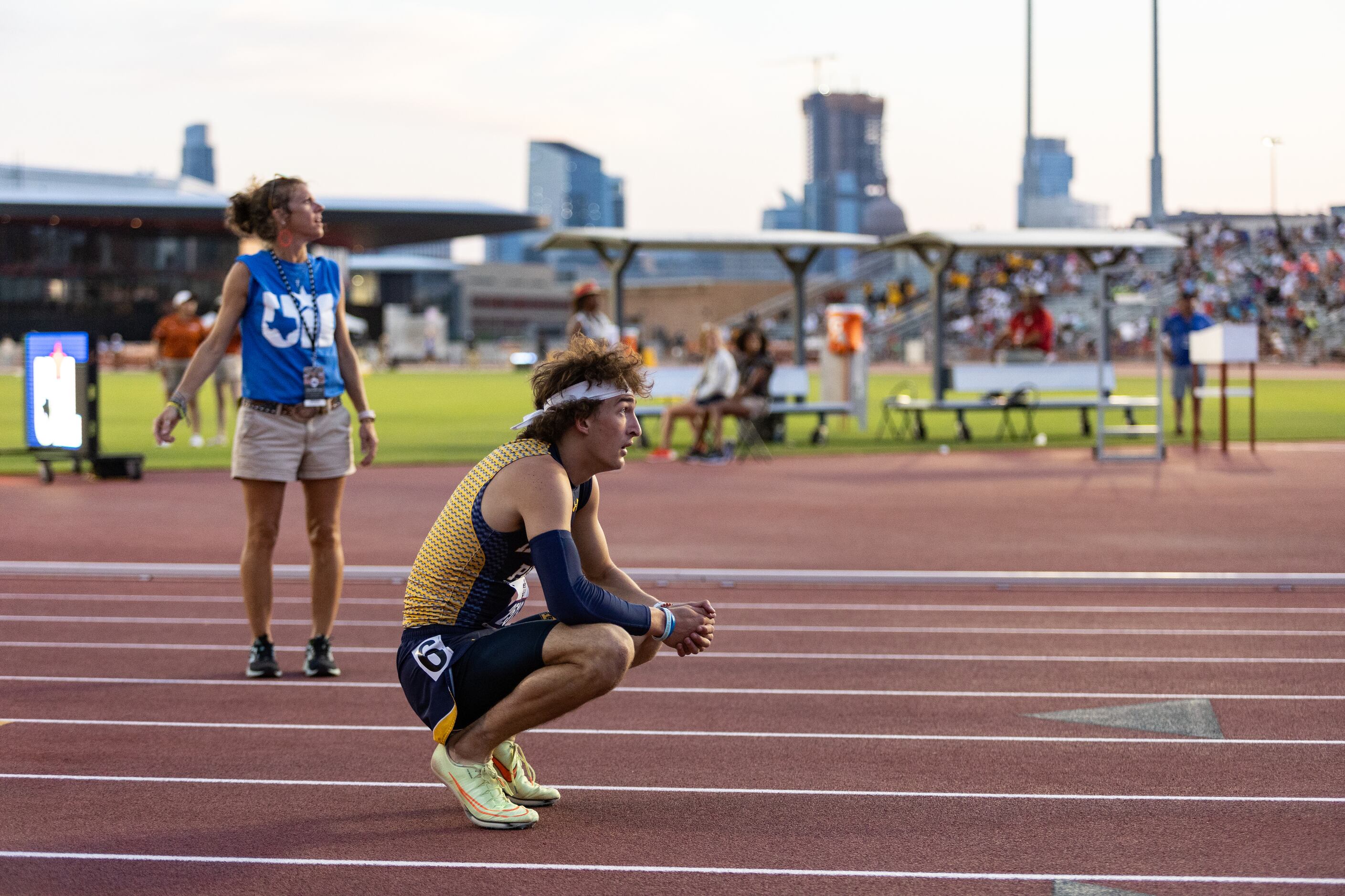 John Rutledge of Dallas Highland Park looks to the scoreboard for official times after the...