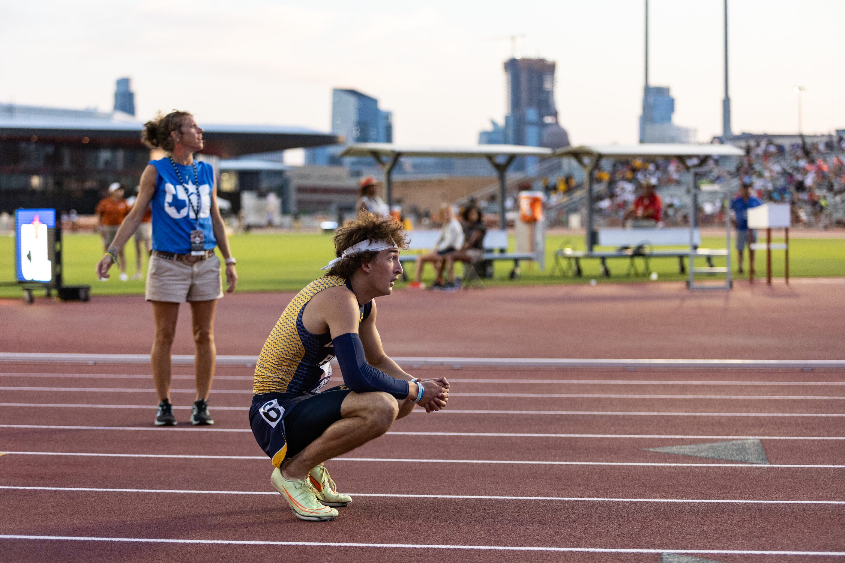 John Rutledge of Dallas Highland Park looks to the scoreboard for official times after the...