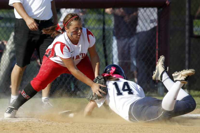 Flower Mound's Kelly Powell (14) slides safely into third under the tag of Flower Mound...