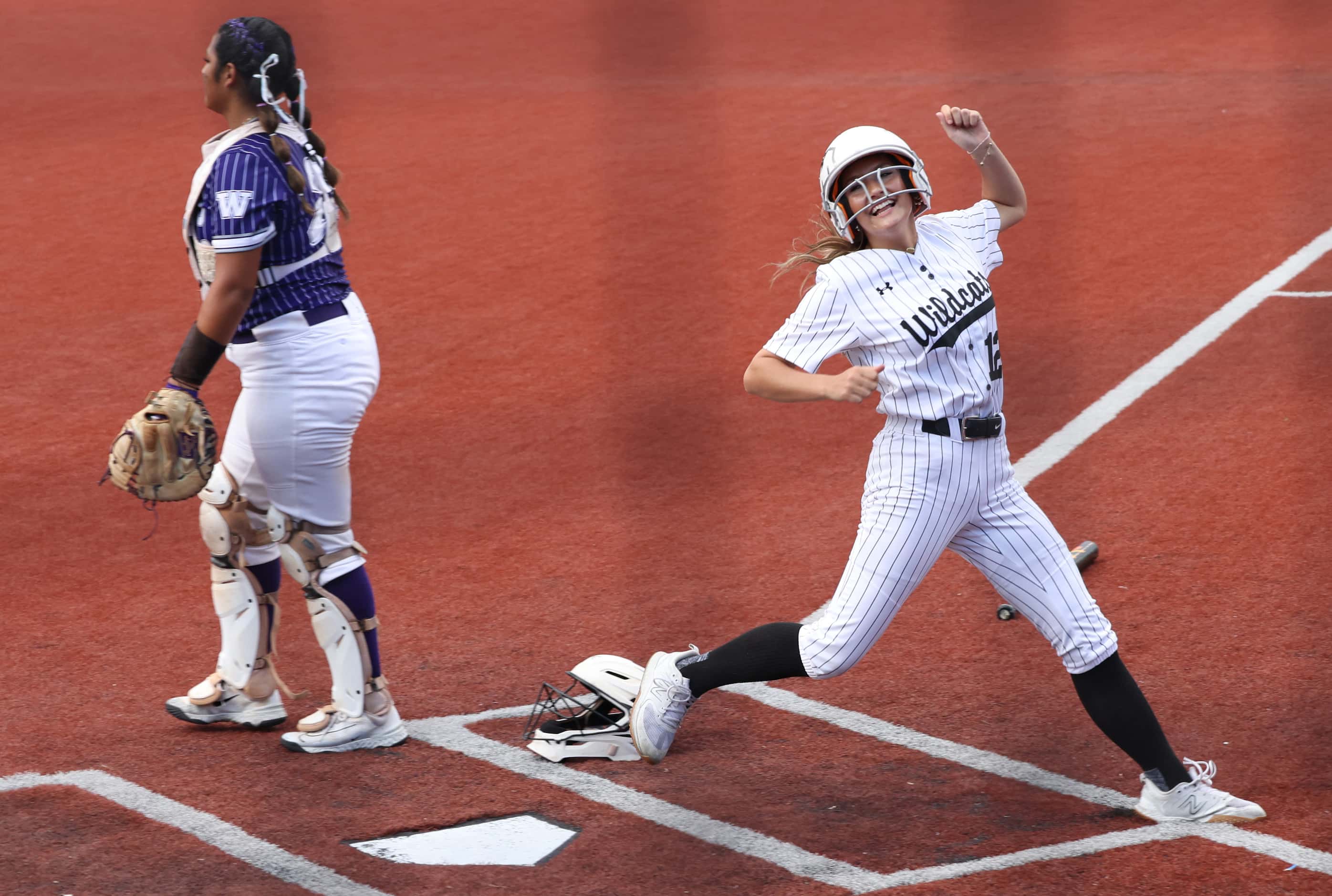 Denton Guyer outfielder Emma Richard (12) was all smiles as she scored as part of a 3-run...