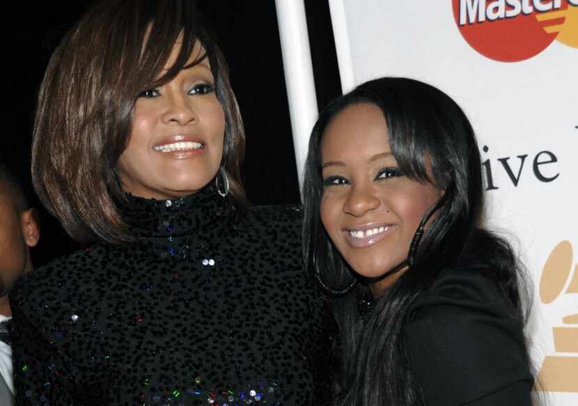 In this Feb. 12, 2011, file photo, singer Whitney Houston, left, and daughter Bobbi Kristina...