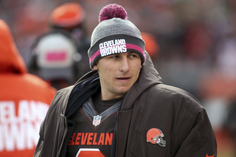 Cleveland Browns quarterback Johnny Manziel watches on the sidelines during the second half...