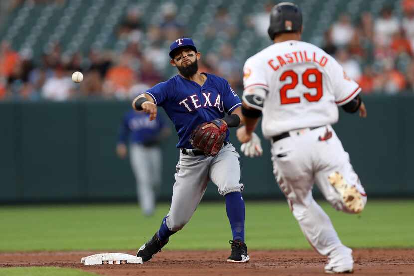 BALTIMORE, MD - JULY 17: Rougned Odor #12 of the Texas Rangers turns the double play as...