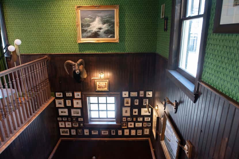 The interior of Merchant House is kitschy, like this wall of black and white photos...
