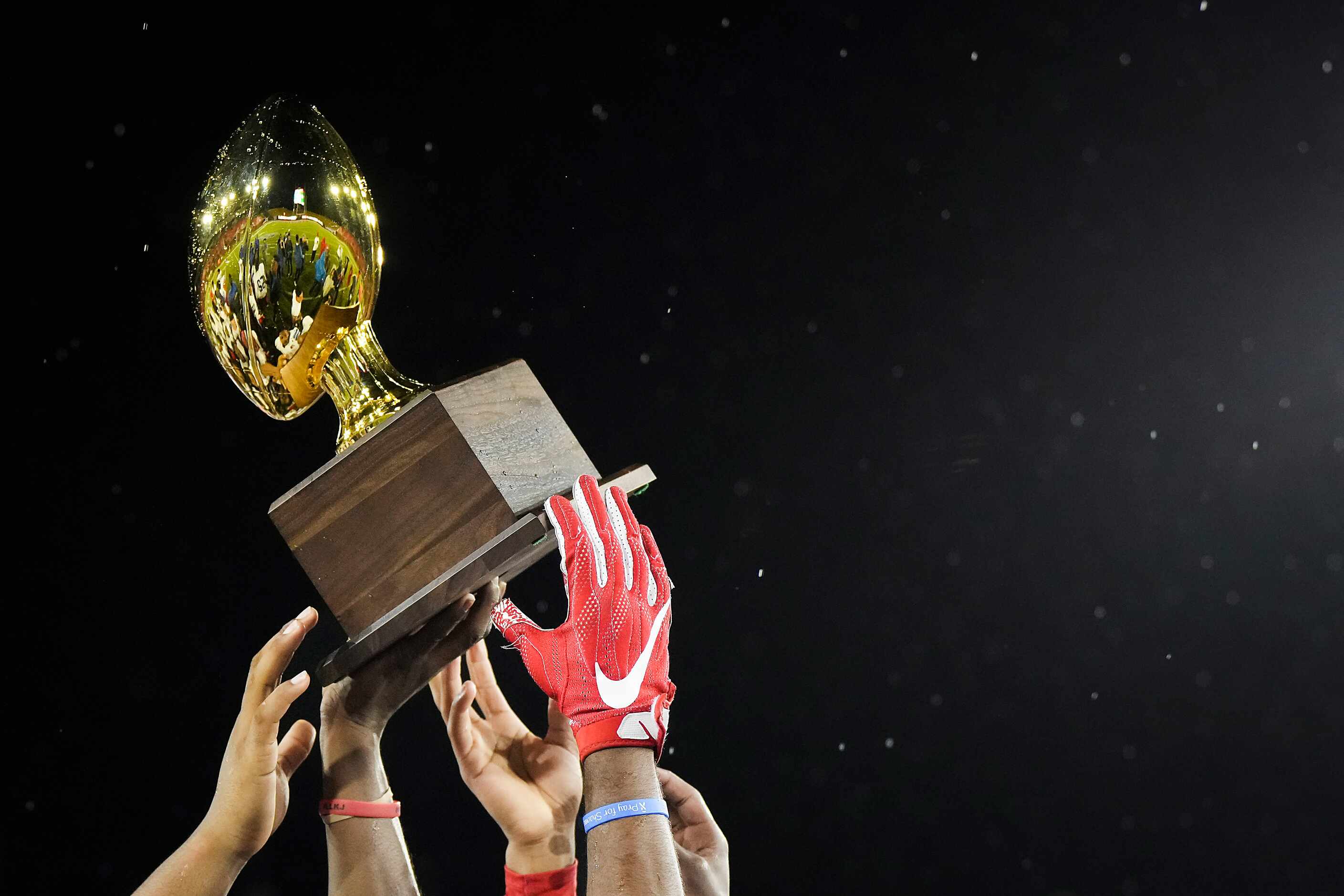 Duncanville players celebrate with the game trophy after a victory over Prosper in a Class...