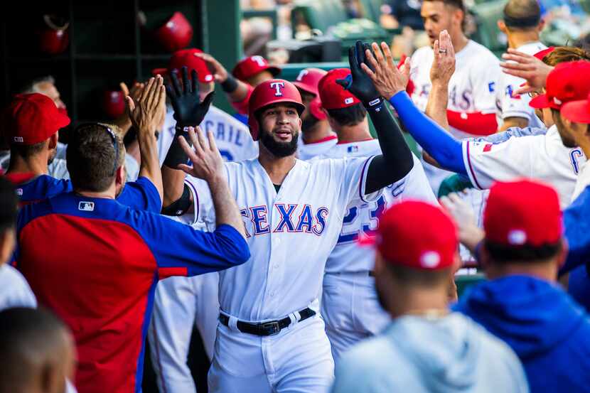 Texas Rangers right fielder Nomar Mazara (30) gets high-fives in the dugout after a home run...