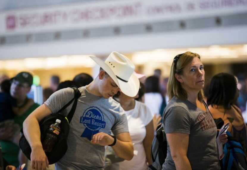  Jackson Shepard of Omaha, Neb., checks his watch while in the security clearance line at...