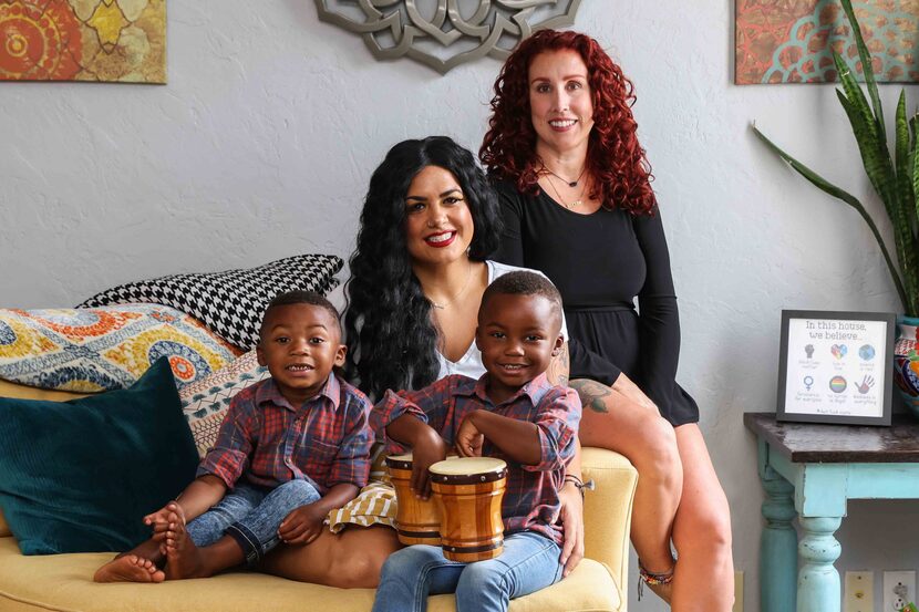 Jantzen Verastique (center), her children Lukah, 3, and Jonah, 4, pose for a portrait with...