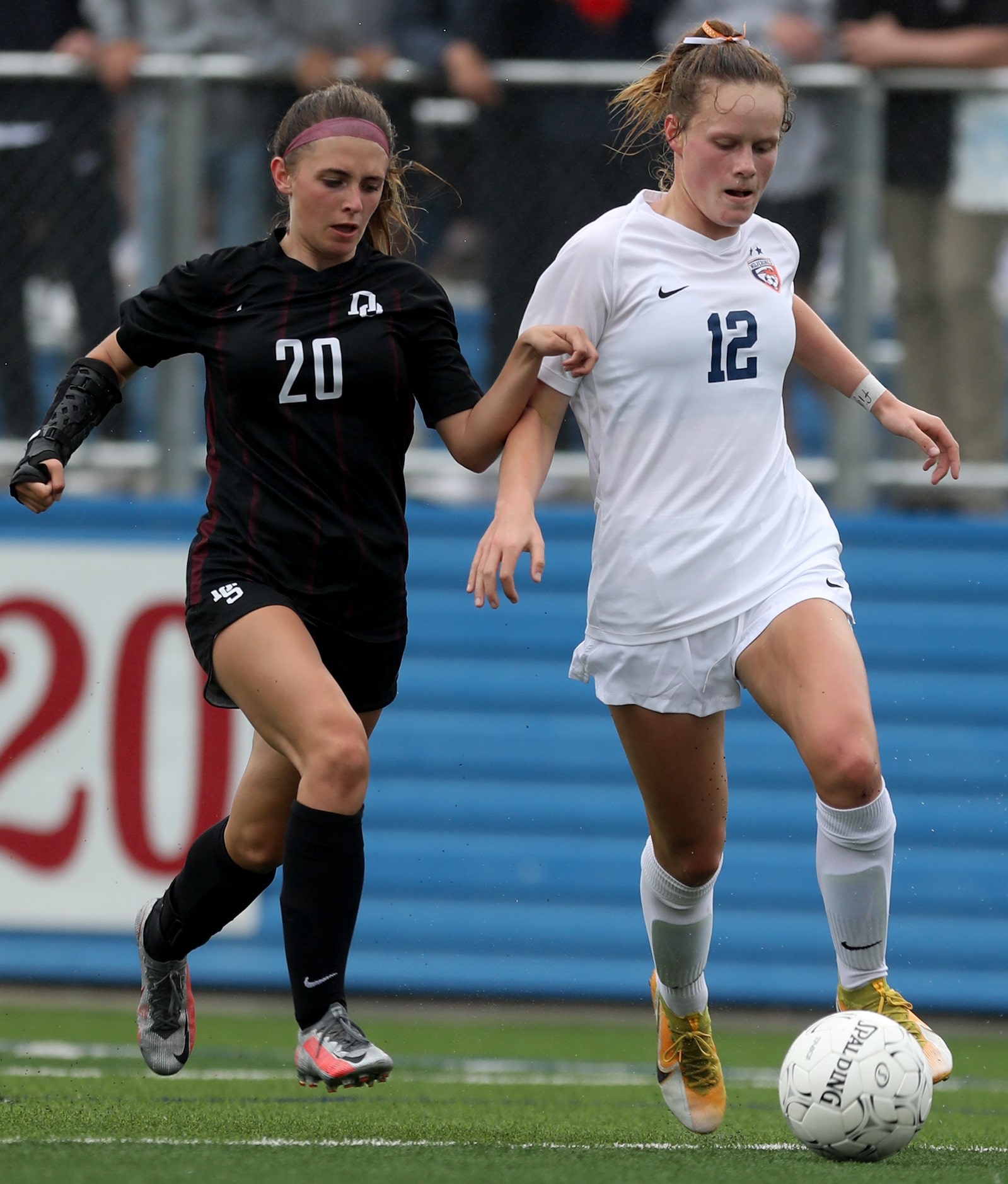 Dripping Springs' Kaleigh Howell (20) and Wakeland's Katy Greyson (12) go after the ball...