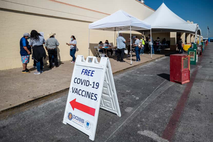 Signage is on display during a pop-up COVID-19 vaccine clinic operated by Dallas County...