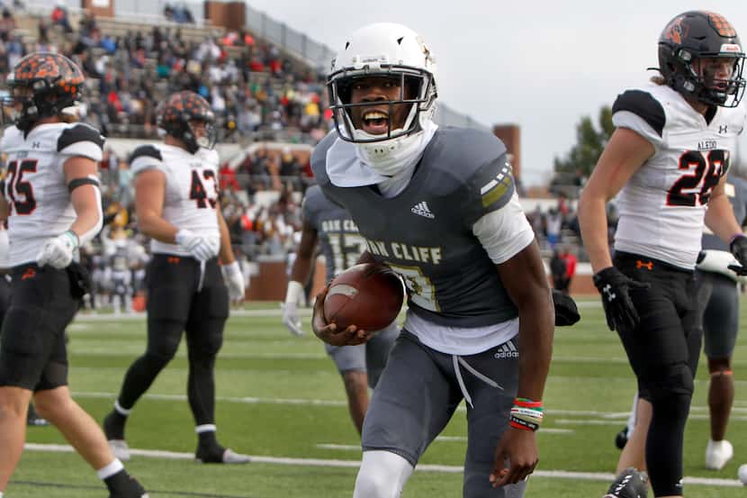 South Oak Cliff quarterback Kevin Henry-Jennings (8) lets out a yell leaving Aledo defenders...