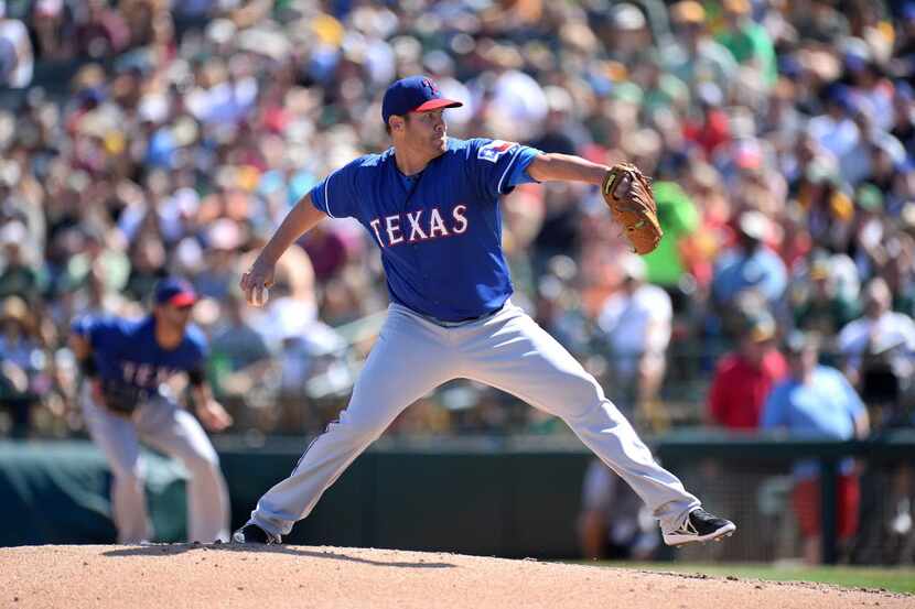 Mar 15, 2014; Phoenix, AZ, USA; Texas Rangers starting pitcher Colby Lewis (48) pitches in...