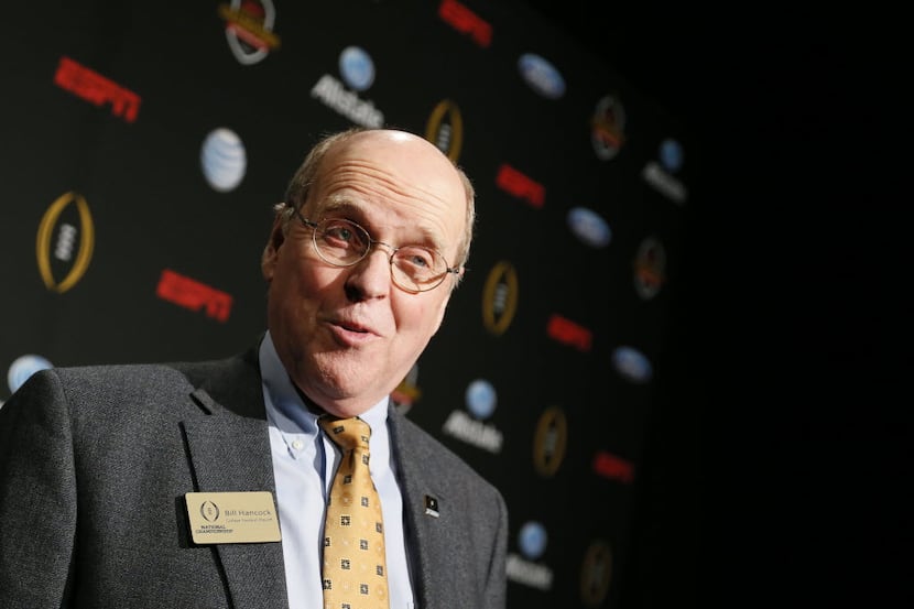 College Football Playoff executive director, Bill Hancock talks to the media on the blue...