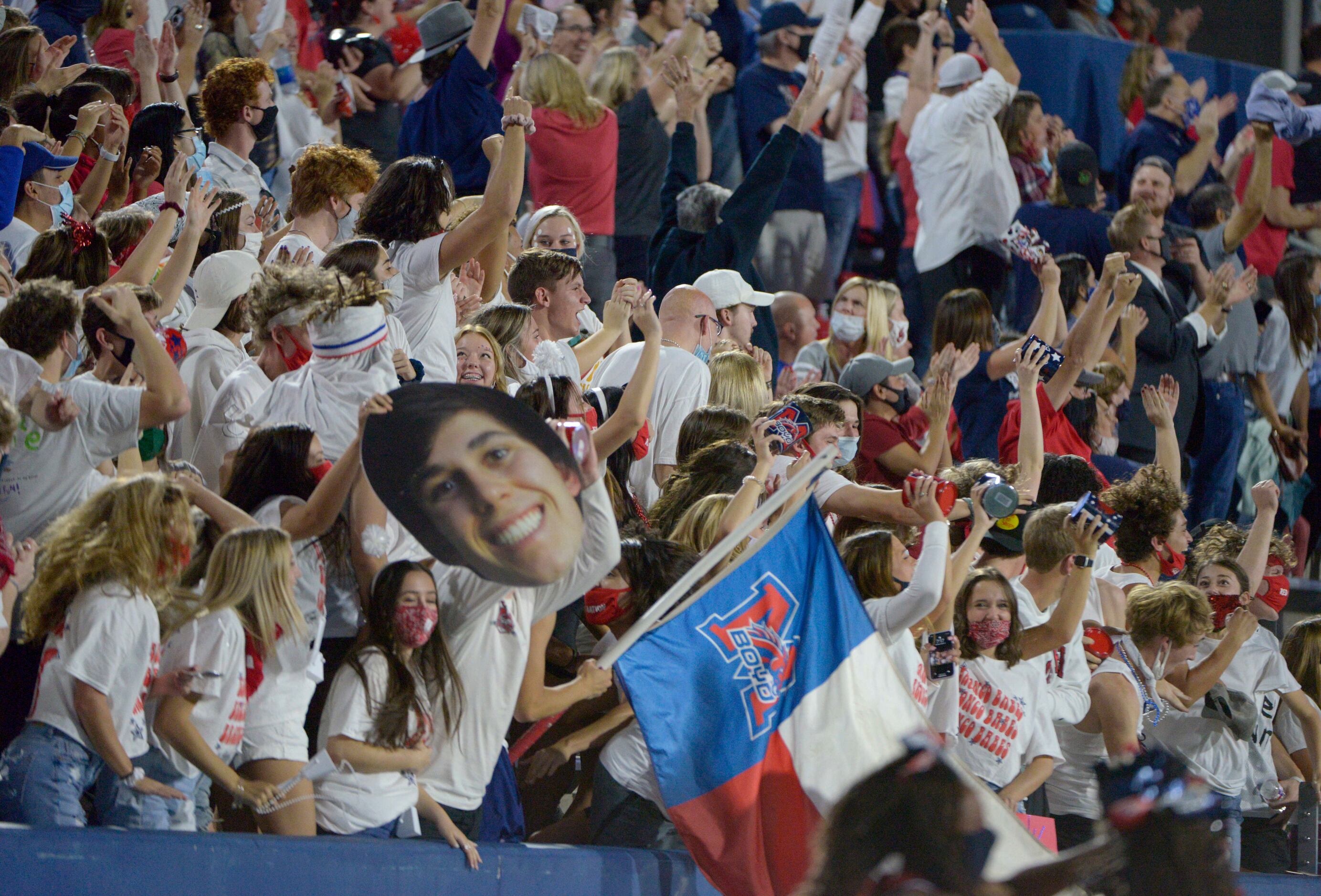 McKinney Boyd student cheer after a touchdown in the first quarter of a high school football...