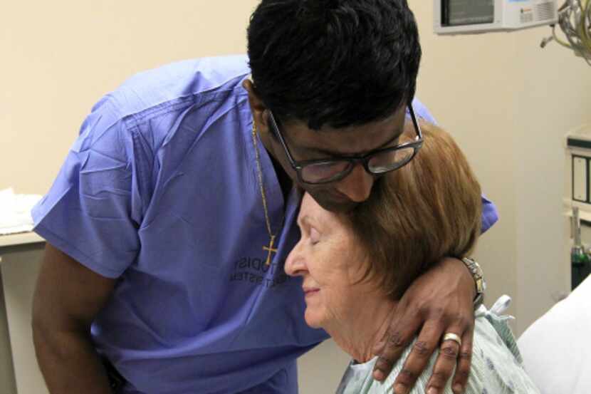 Dr. Rohan Jeyarajah hugged Mary Jane Moix, 69, of Conway, Ark., after they prayed with her...