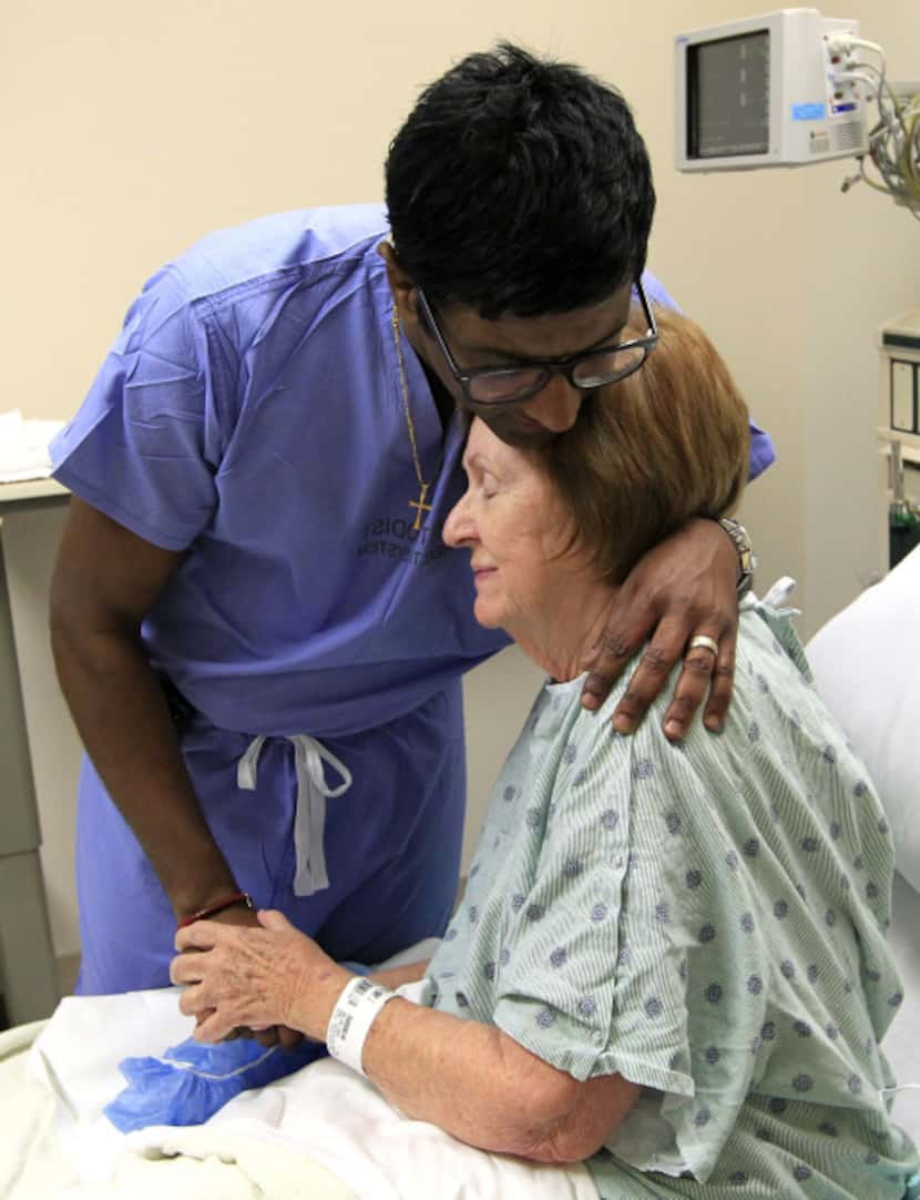 Dr. Rohan Jeyarajah hugged Mary Jane Moix, 69, of Conway, Ark., after they prayed with her...