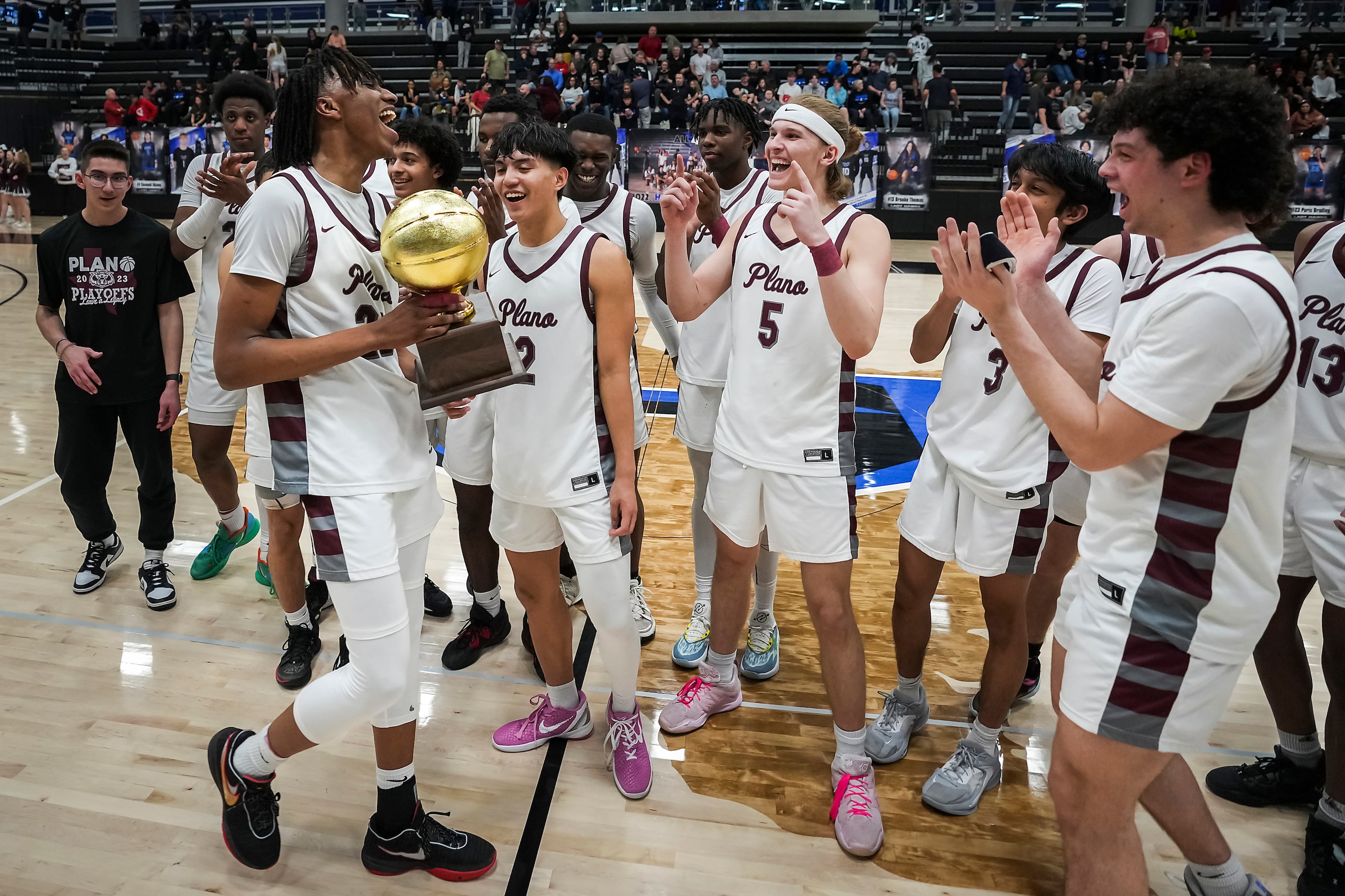 Plano forward Nikk Williams (22) celebrates with the game trophy after a victory over Denton...