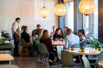 Business colleagues chat during the lunch hour at Sachet in Highland Park.