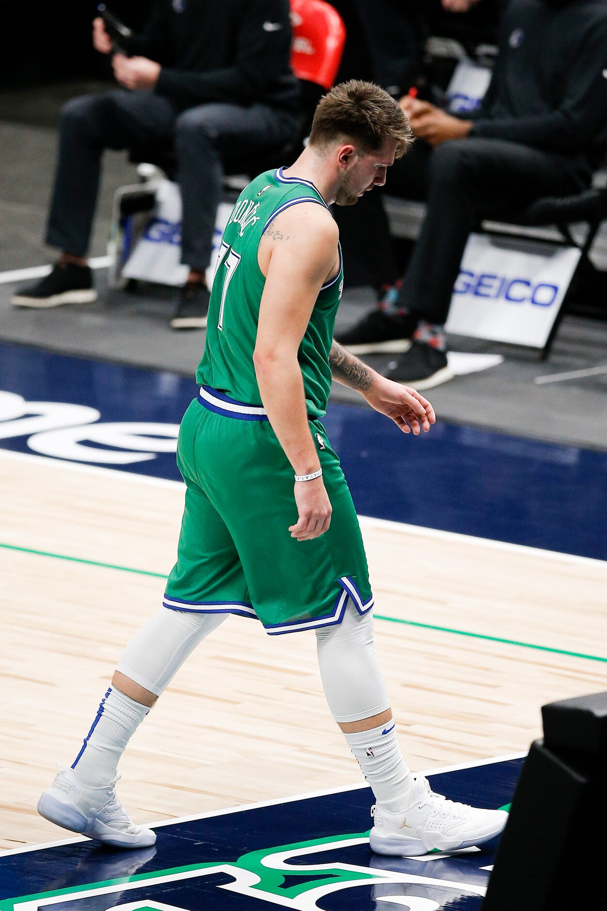 Dallas Mavericks guard Luka Doncic (77) heads to the bench after committing a second...