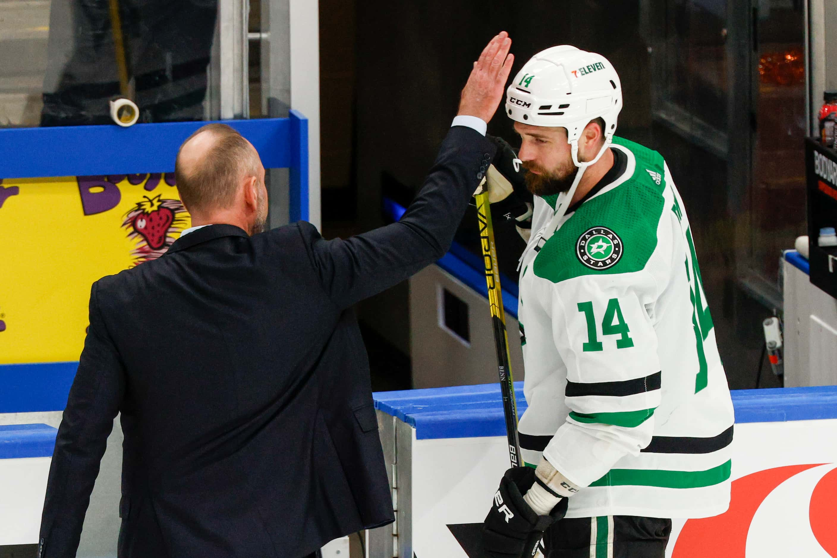 Dallas Stars head coach Pete DeBoer taps Dallas Stars left wing Jamie Benn on the head after...