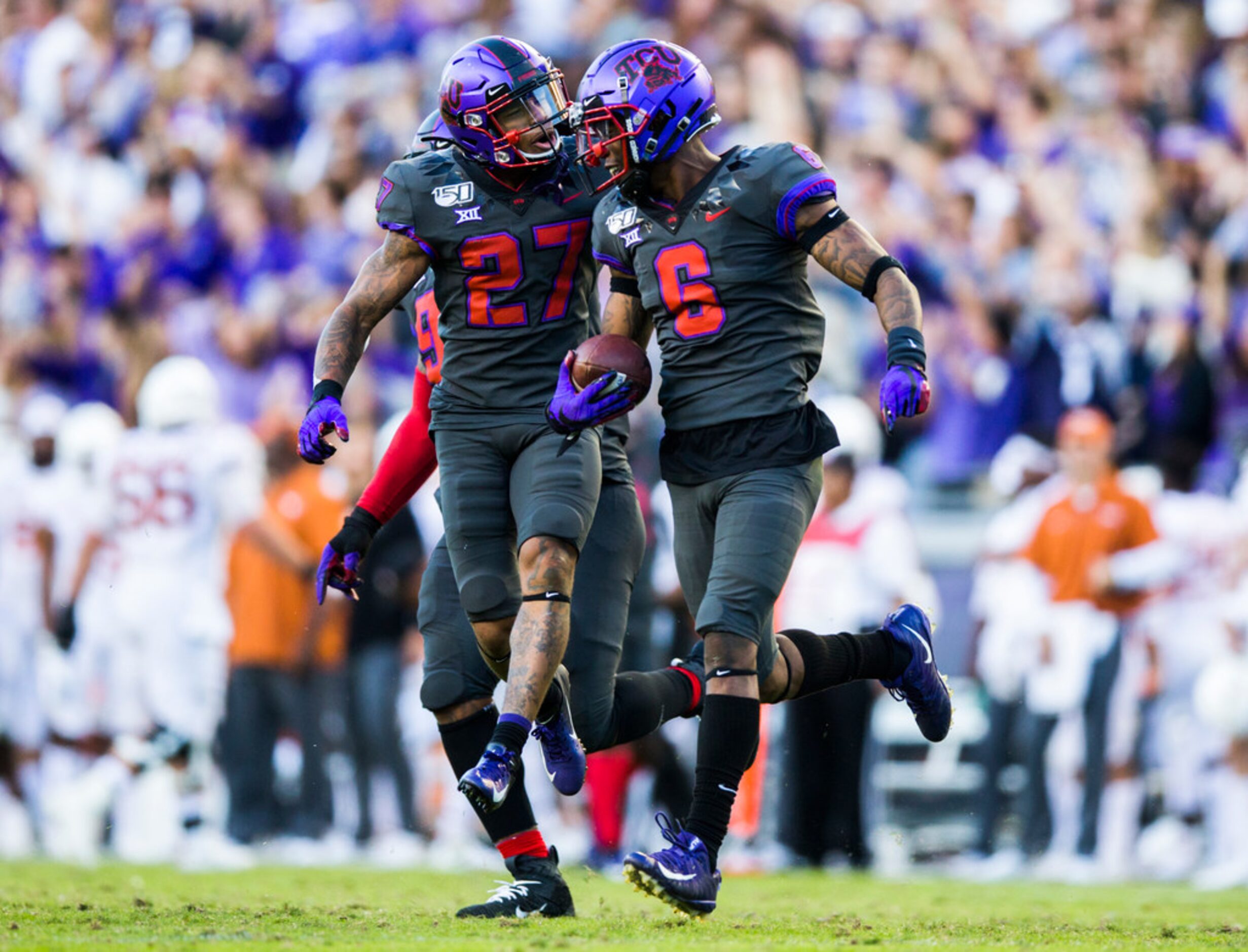 TCU Horned Frogs safety Ar'Darius Washington (27) and safety Innis Gaines (6) celebrate...